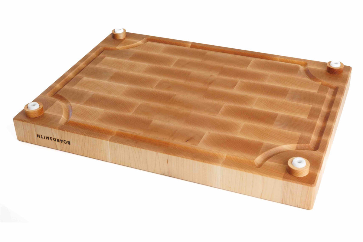 Maple end grain cutting board with juice groove and polyurethane feet by The Boardsmith