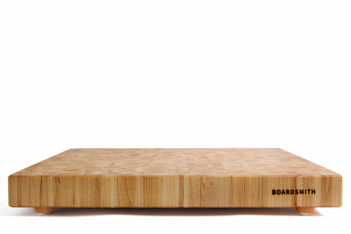 Maple mosaic end grain cutting board with feet by The Boardsmith