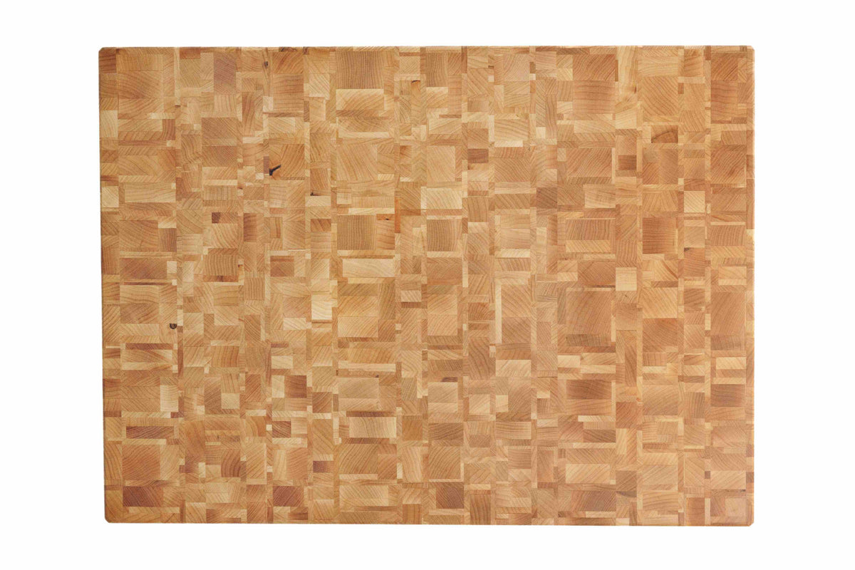 End-grain cutting board showing a mosaic pattern of light maple blocks.